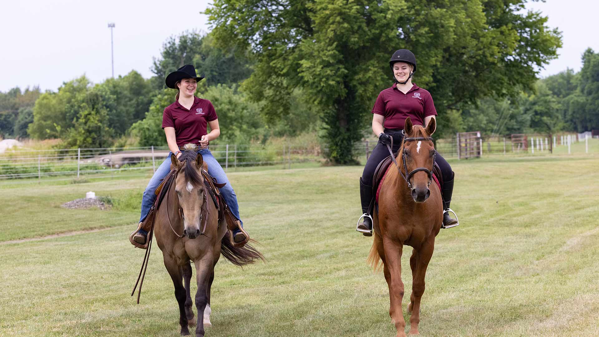 Two equine students riding their horses at Darr Agricultural Center.