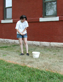 Adelle taking a soil sample for analysis