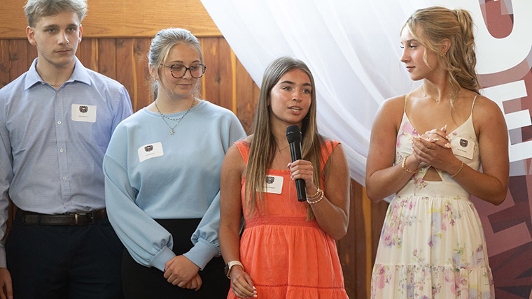 A group of new Missouri State students speaking at a scholarship event.