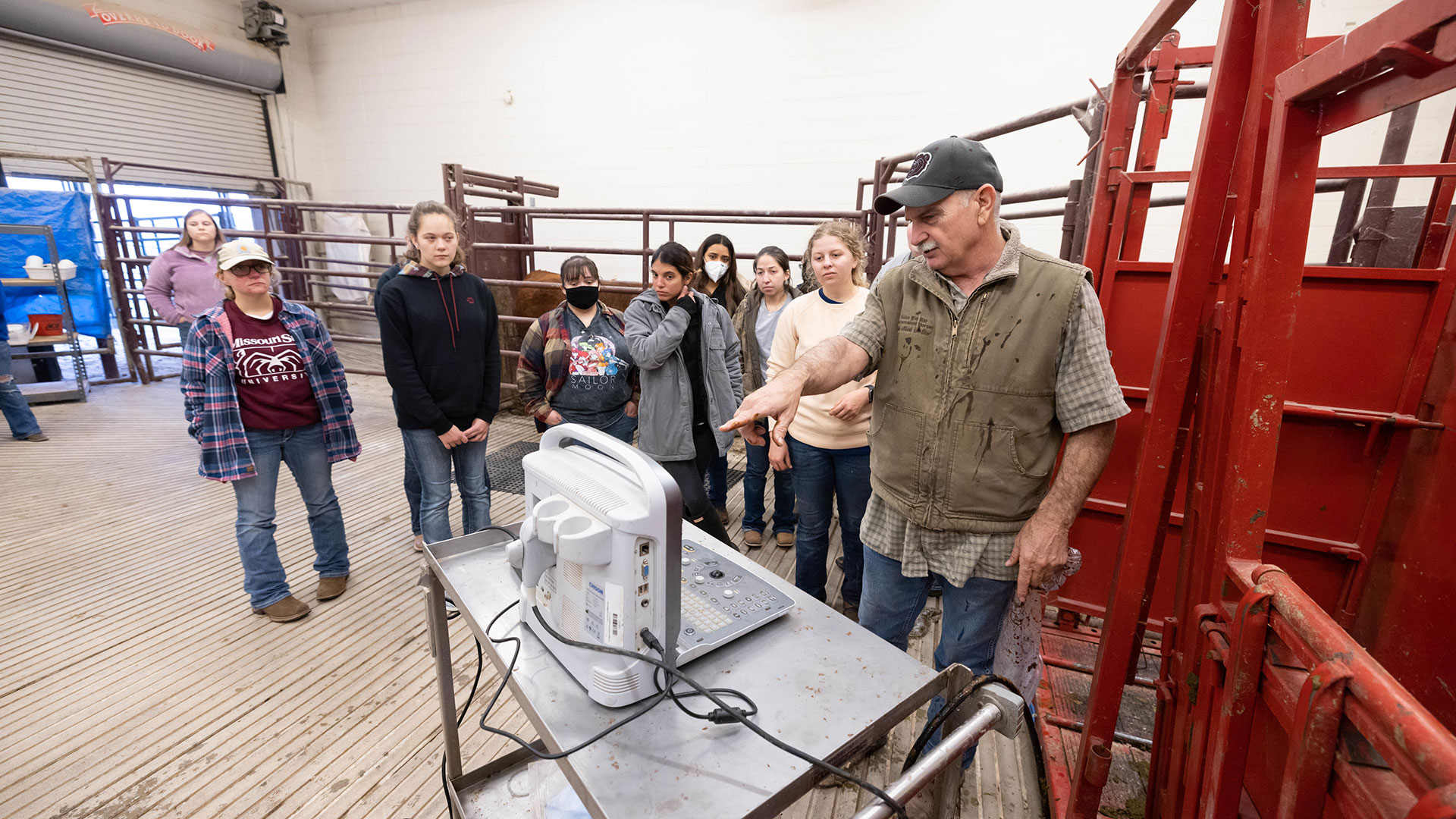 Dr. Gary Webb shows his class the monitoring system for calf vaccination and testing.