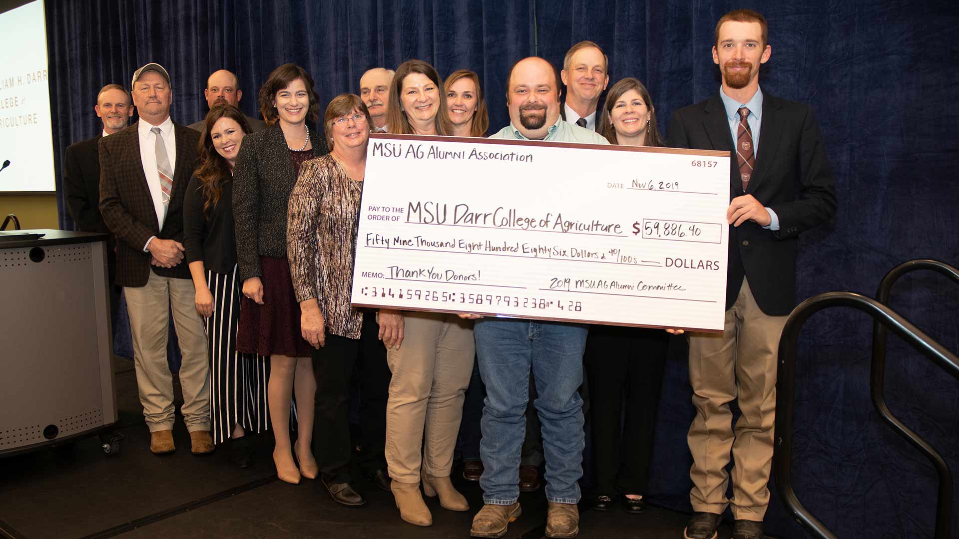 Darr College of Agriculture faculty and staff accepting donation check from alumni association.