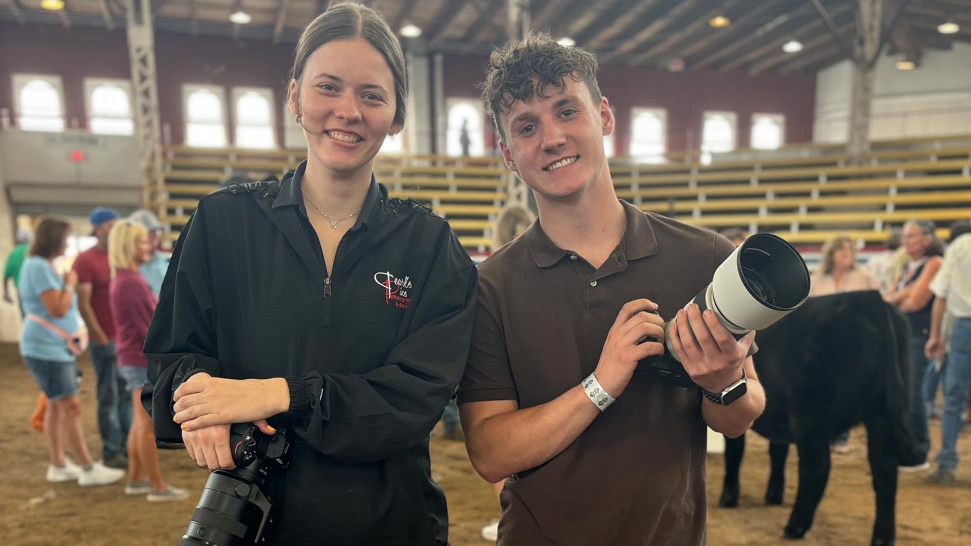 Two students posing with their cameras while doing photography at the Missouri State Fair in Sedalia.