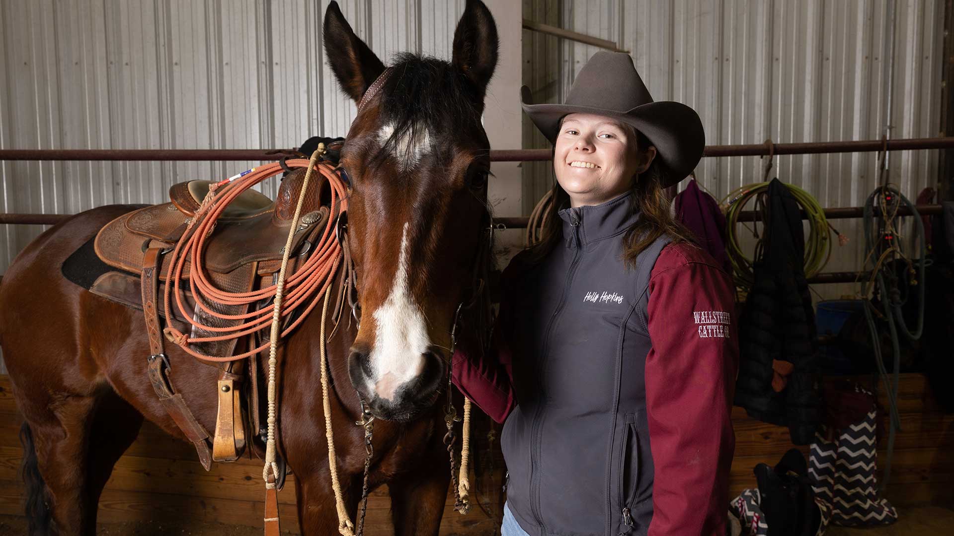 A member of the Missouri State Ranch Horse Team poses with her horse.