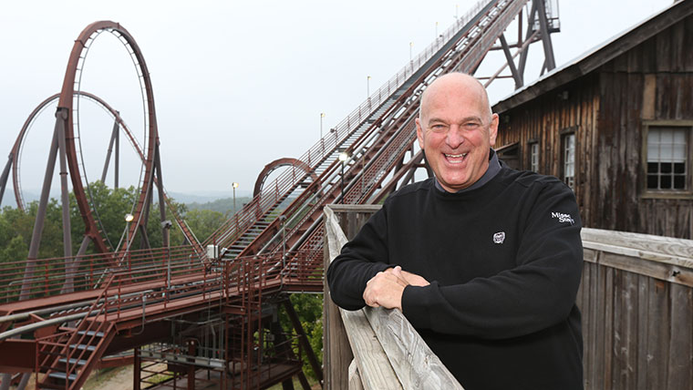 Brad Thomas, senior vice president of Silver Dollar City, poses in front of the Wildfire rollercoaster.